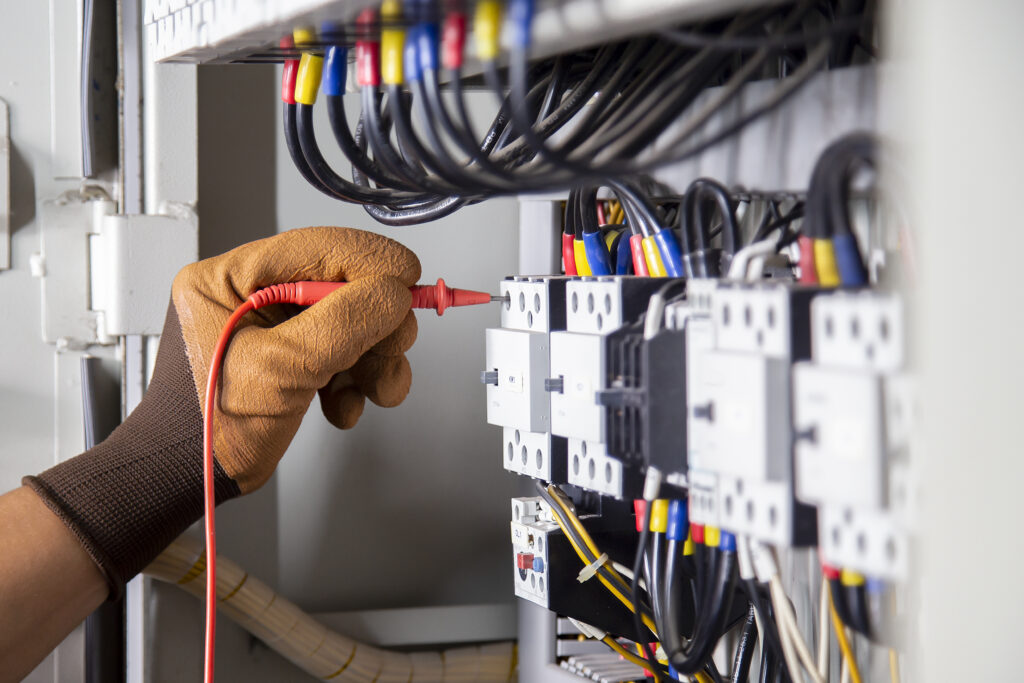 electrical-engineer-checks-electrical-system-by-measuring-with-multimeter